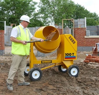 Man feeding into Winget 100T mixer